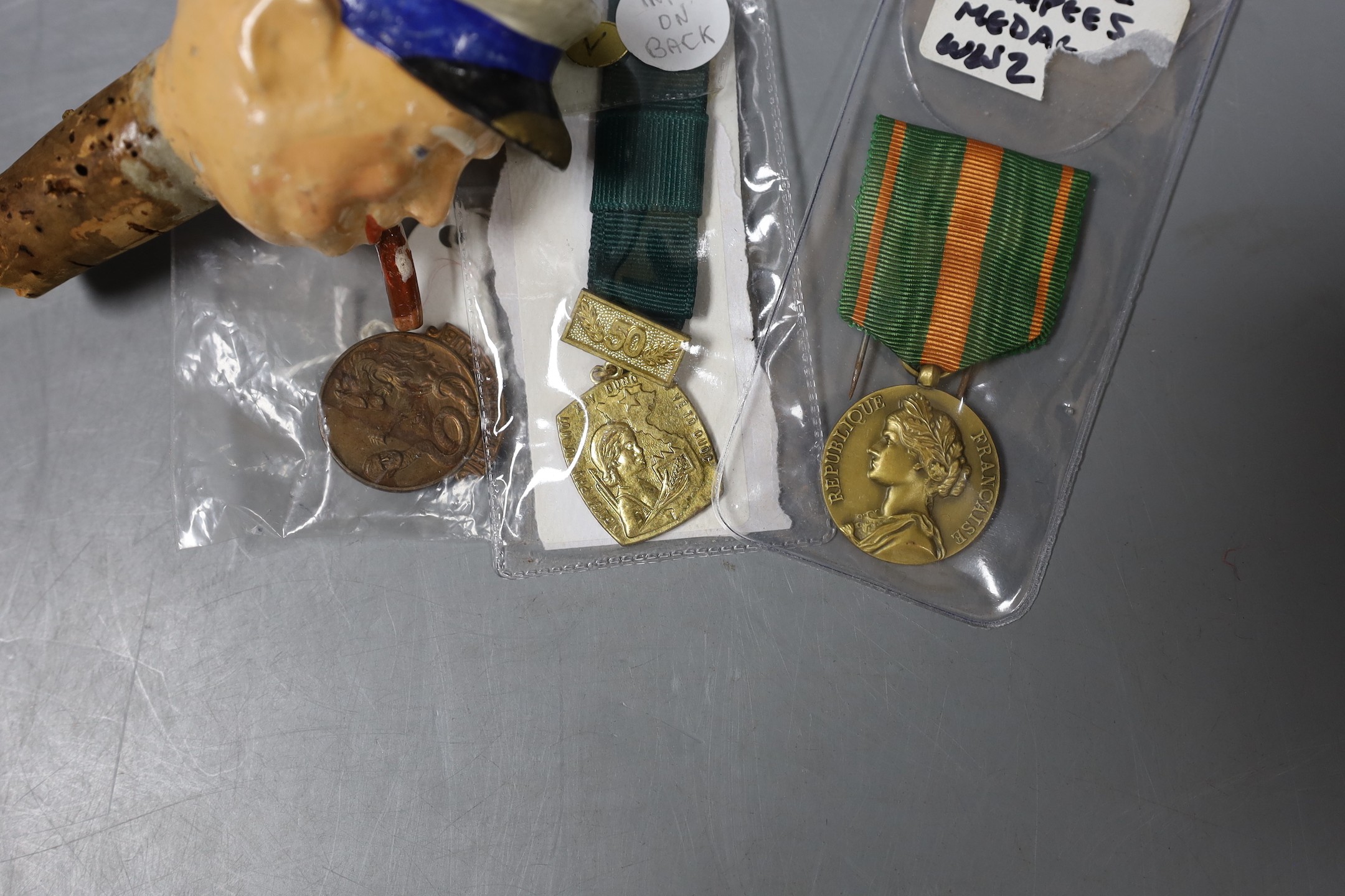 WWII interest: a Churchill composition drinks dispenser, France Escapees medal, a British Hitler hate club badge and a North Vietnam women's Defence of the Fatherland medal